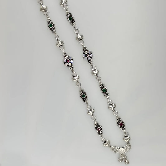 Sterling silver necklace with heart links, green and red stones, and clear crystals