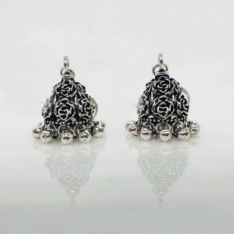 Pair of oxidized silver floral jhumka earrings with intricate rose patterns and dangling beads