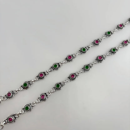 Silver chain anklets with alternating pink and green round stones on white background