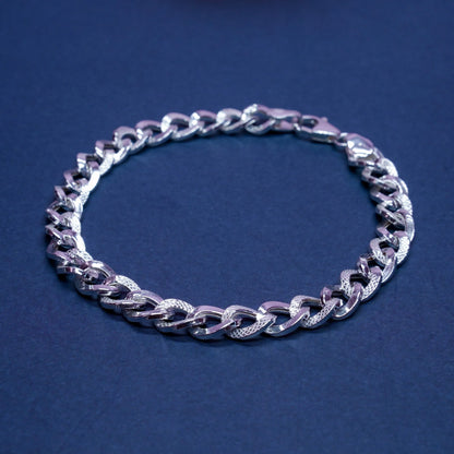Silver textured chain bracelet on dark blue background, men's fashion jewelry